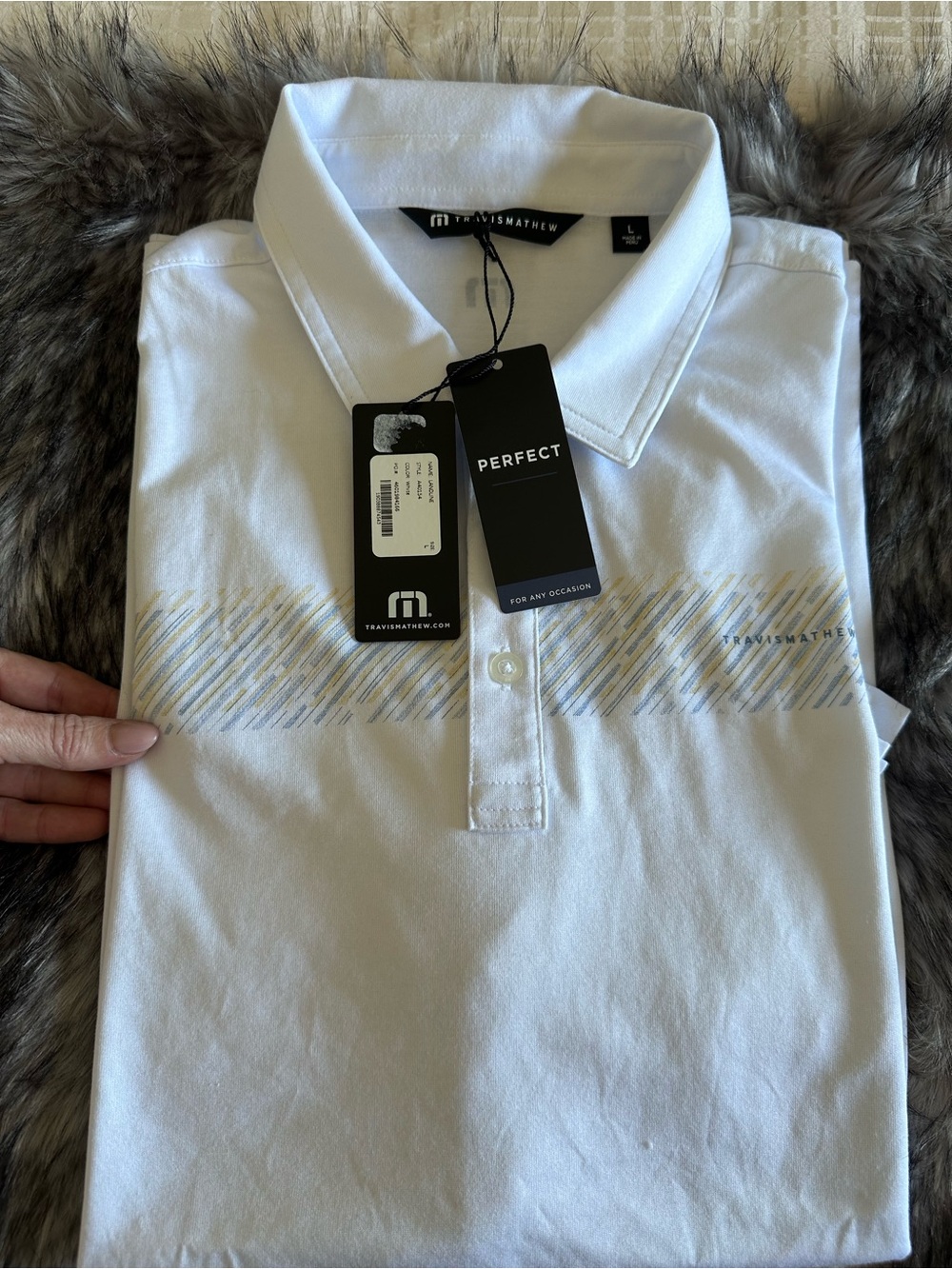 Travis Mathew White Polo with Subtle Yellow and Light Blue Stripe Accents
